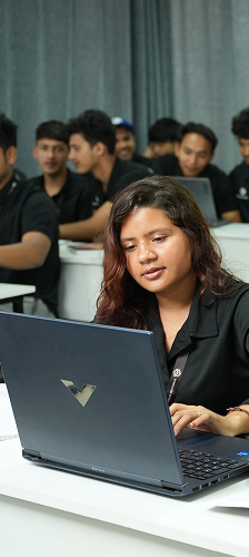 Student working on laptop in classroom